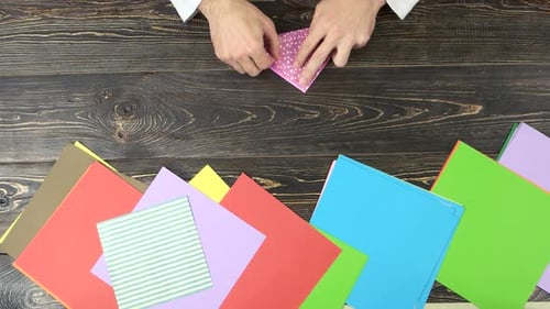 Hands Making Origami, Top View.