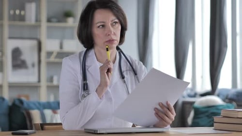 Doctor Studies Paperwork in Bright Office