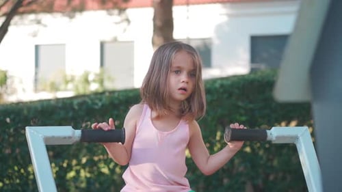 Active Little Girl Child Trains on Simulator City Park