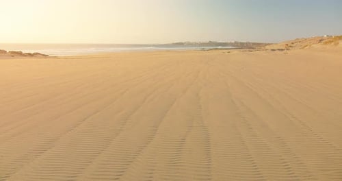 Sand Blowing in the Wind on Paradise Beach at Sunset