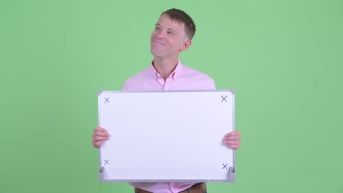 Happy Businessman Thinking While Holding White Board