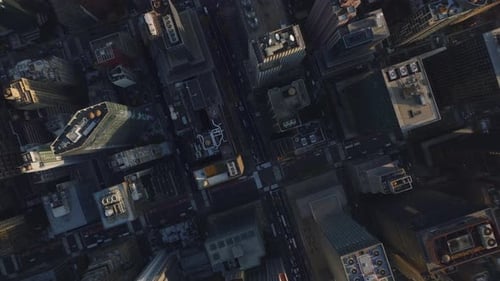 Aerial Birds Eye Overhead Top Down Panning View of Tall Buildings in Midtown Lit By Low Sun