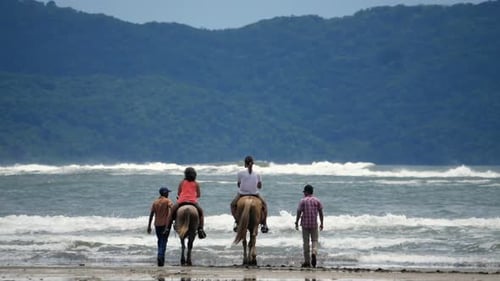 Family Riding Horses on the Seashore