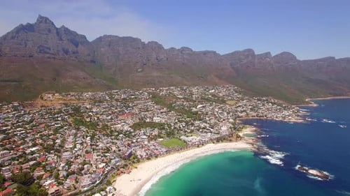 Aerial travel drone view of Camps Bay beach, Cape Town, South Africa.