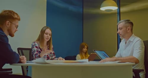 Young Woman in the Office with Colleagues Discussing the Company's Business Plans
