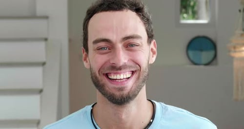 Closeup Portrait of a Pleasant Positive Handsome Caucasian Young Man Cheerfully Laughing Looking at