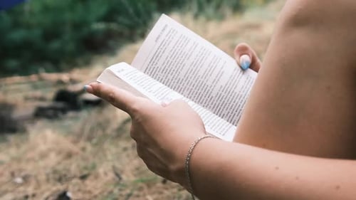 Woman Reading Book Outdoors in Nature