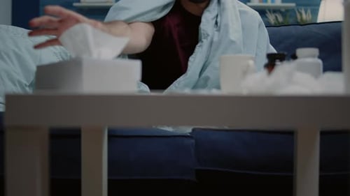 Close Up of Man with Cold and Flu Blowing Runny Nose