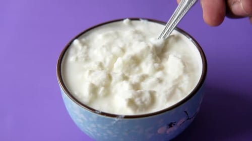 Close Up of Fresh Yogurt in a Bowl on Color Background