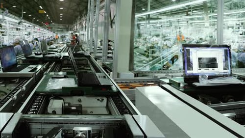 Workers and Machines Assembling Laptops at Electronics Factory - 4K