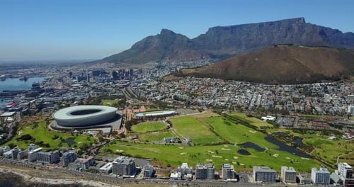 Aerial View of Cityscape with Stadium and Mountains