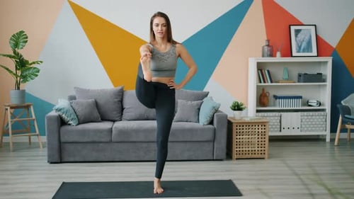 Woman Doing a Standing Yoga Pose at Home