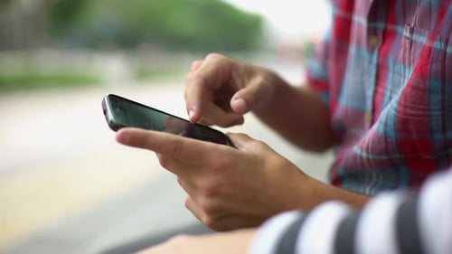 Close Up of Hands Using Smartphone