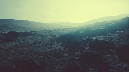 Snow Covered Rocky Hill in Middle of Desert on Cloudy Day