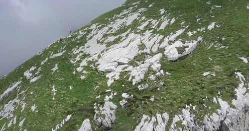 Aerial drone view of hikers hiking in the mountains.