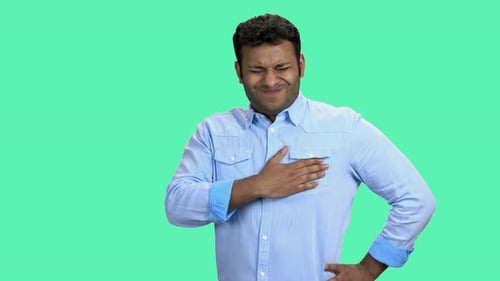 Man Holding Chest in Pain on Green Screen