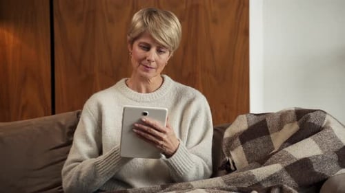 Woman Relaxing with Tablet at Home