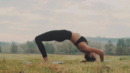 Girl Doing Yoga Exercises Outdoors.
