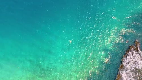 Few People Swimming At The Remote Beach With Blue Sea In Croatia. - aerial