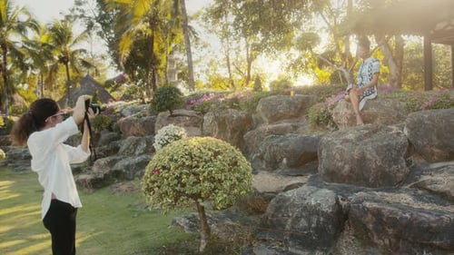 Fashion Model Posing in Tropical Garden for Photographer