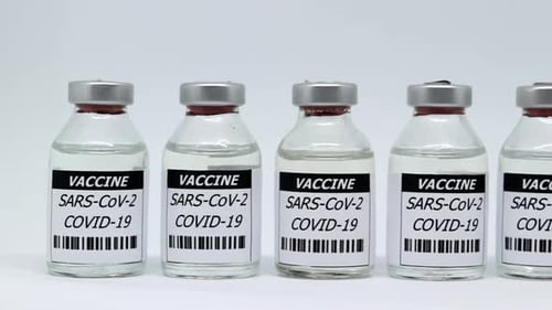 Row Of Covid Vaccine Glass Vials Isolated In White Background - Sars-Cov-2 Vaccination Concept - sli