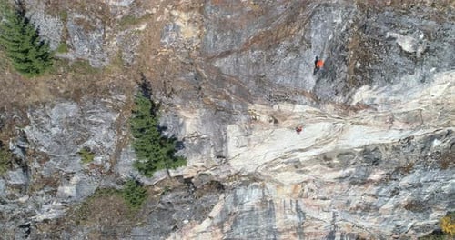 Climber climbing rocky mountain 4k
