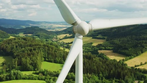 Close Up a Propeller of the Windmill in the Field with Mountains on the Background