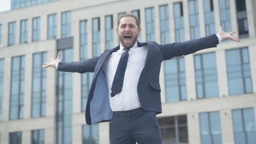 Celebrating Businessman in Front of Office Building