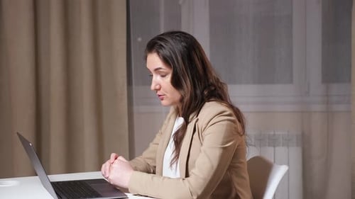 Young Brunette Talks on Video Call and Sighs with a Relief