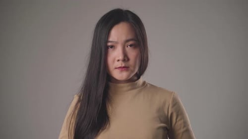 Young Woman Stares Seriously At The Camera