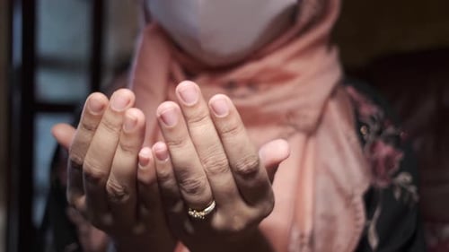 Muslimische Frauen mit Gesichtsmaske beten im Ramadan