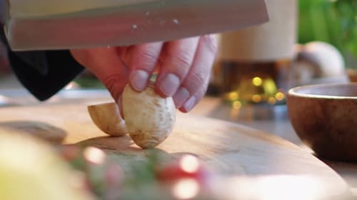 Close Up of Male Hands Slicing Mushroom with Butcher Knife