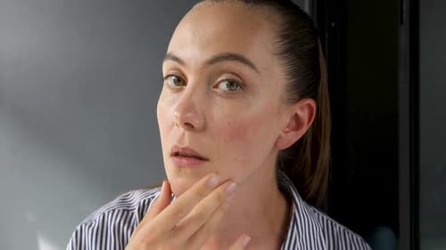 Woman Examining Her Face and Skin