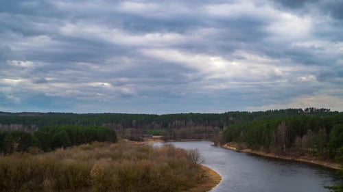 Spring landscape with river and storm clouds, time lapse