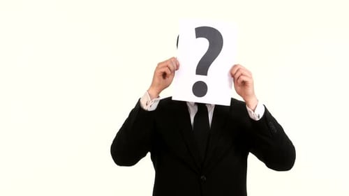 Young Businessman Holding a White Billboard with a Question Mark on It