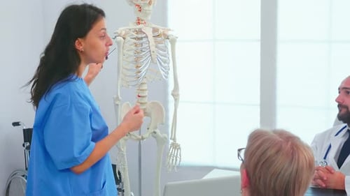 Medical Professionals Meeting with Skeleton in Bright Clinic