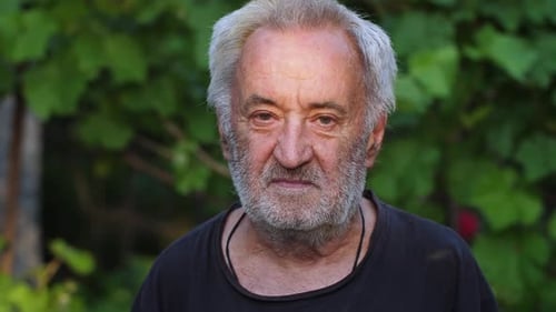 Mature Man's Portrait with Gray Hair in Nature