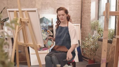 Female Artist Painting in an Art Studio