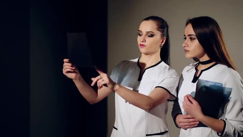 Medical Professionals Analyzing X-Ray in Hospital Setting