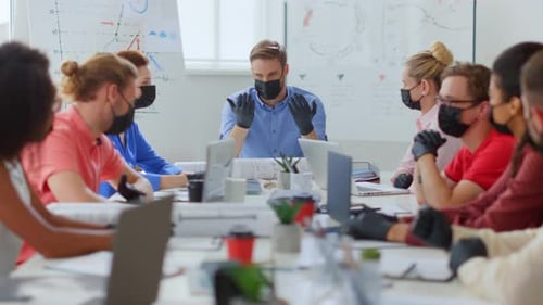 Masked People Sitting Table in Office