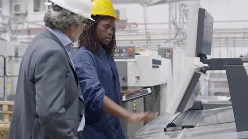 Black Female Factory Engineer Showing New Machines
