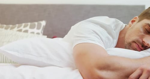 Young man sleeping on bed in the bedroom 4K 4k