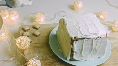 I Put and Spread the Cream on the Cake with the Help of a Spoon