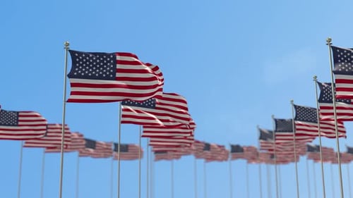 Patriotic American Flags Waving Under a Bright Blue Sky