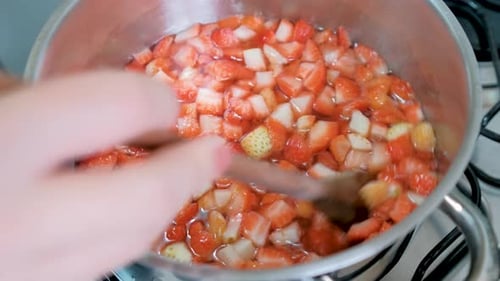 Strawberries Being Stirred in Pot on Stovetop