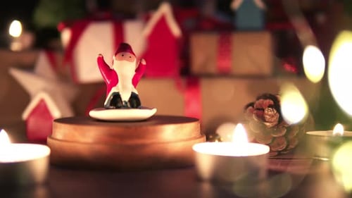 Santa Figurine with Festive Gifts and Candles