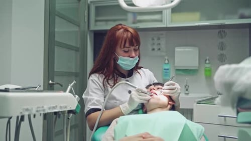 Dentist and patient in dentist office. Dental clinic.