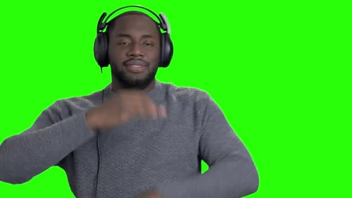 Man in Headphones Is Dancing on Green Screen.