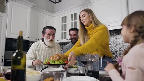 Family Gathered Around Table for Holiday Dinner