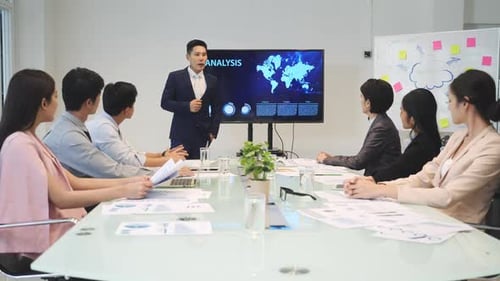 Business Presentation to Diverse Colleagues in Modern Office